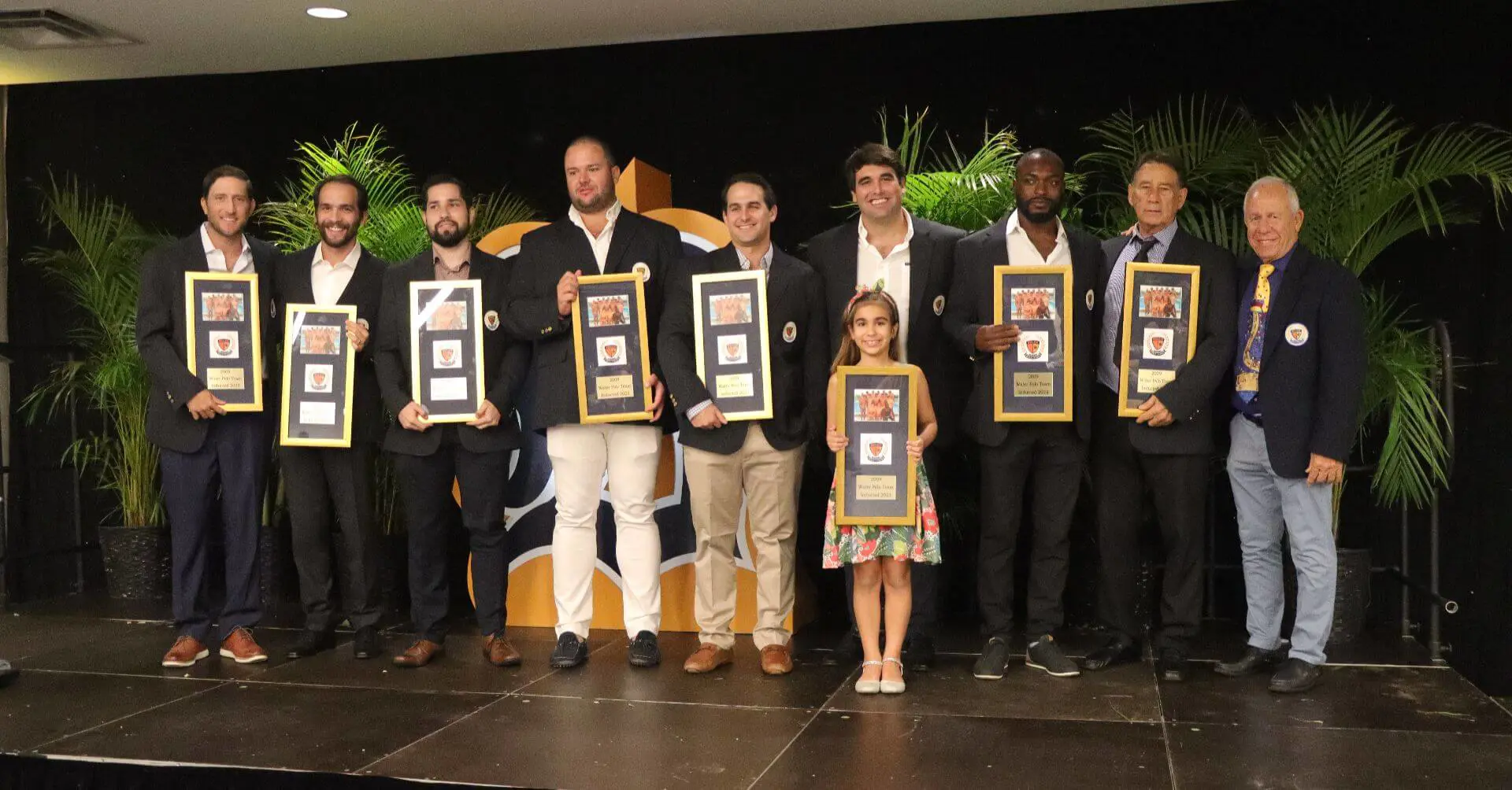 Belen Jesuit Alumni holding awards at the May 2023 Sports Hall of Fame Induction Ceremony.
