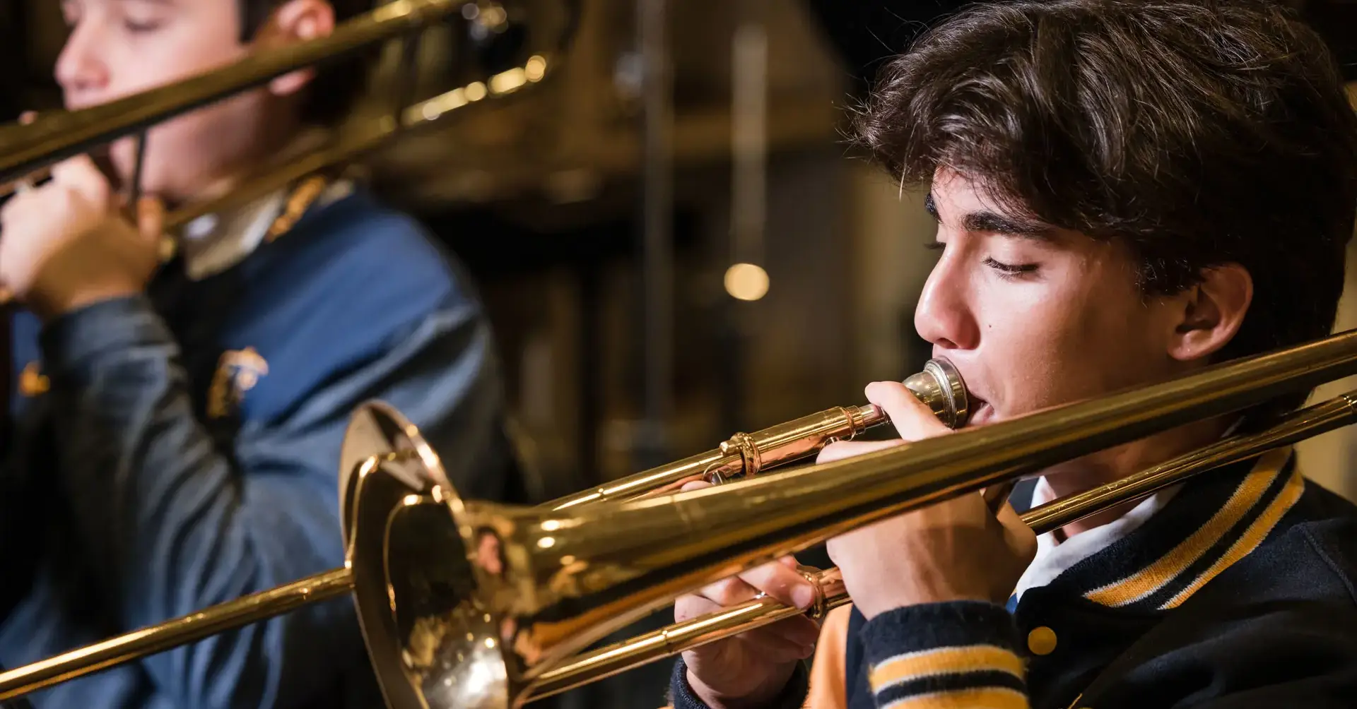 Belen Jesuit student playing a trombone in band class.