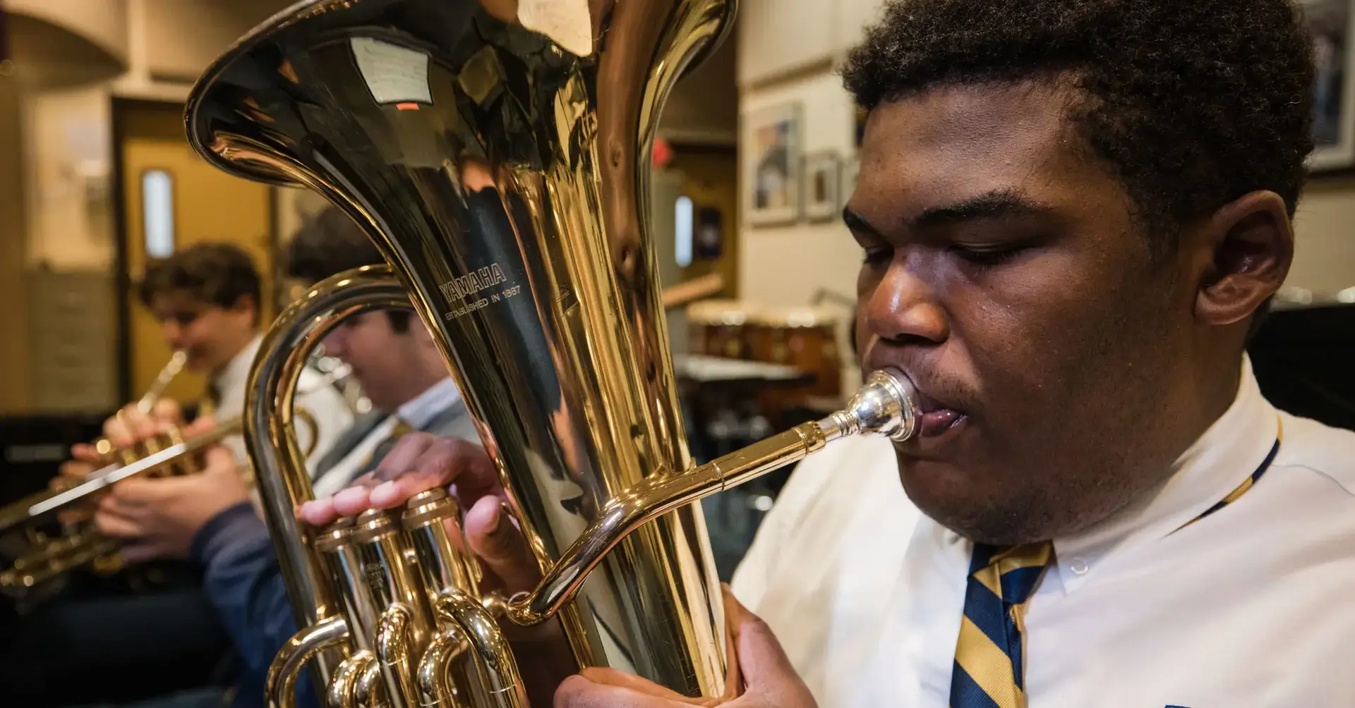 Belen Jesuit student playing a euphonium in band class.