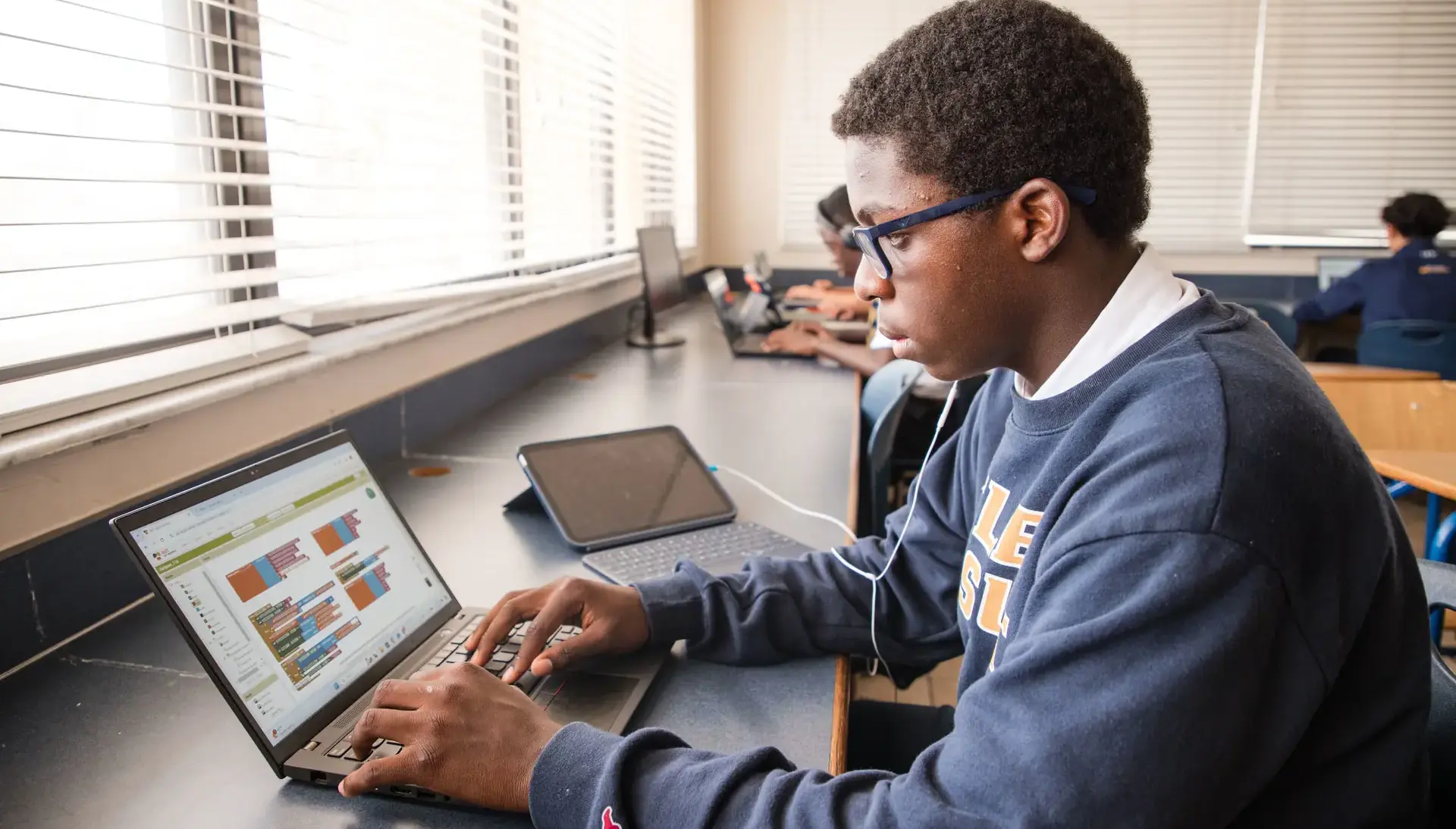 Belen Jesuit student working on laptop in a STEAM class.