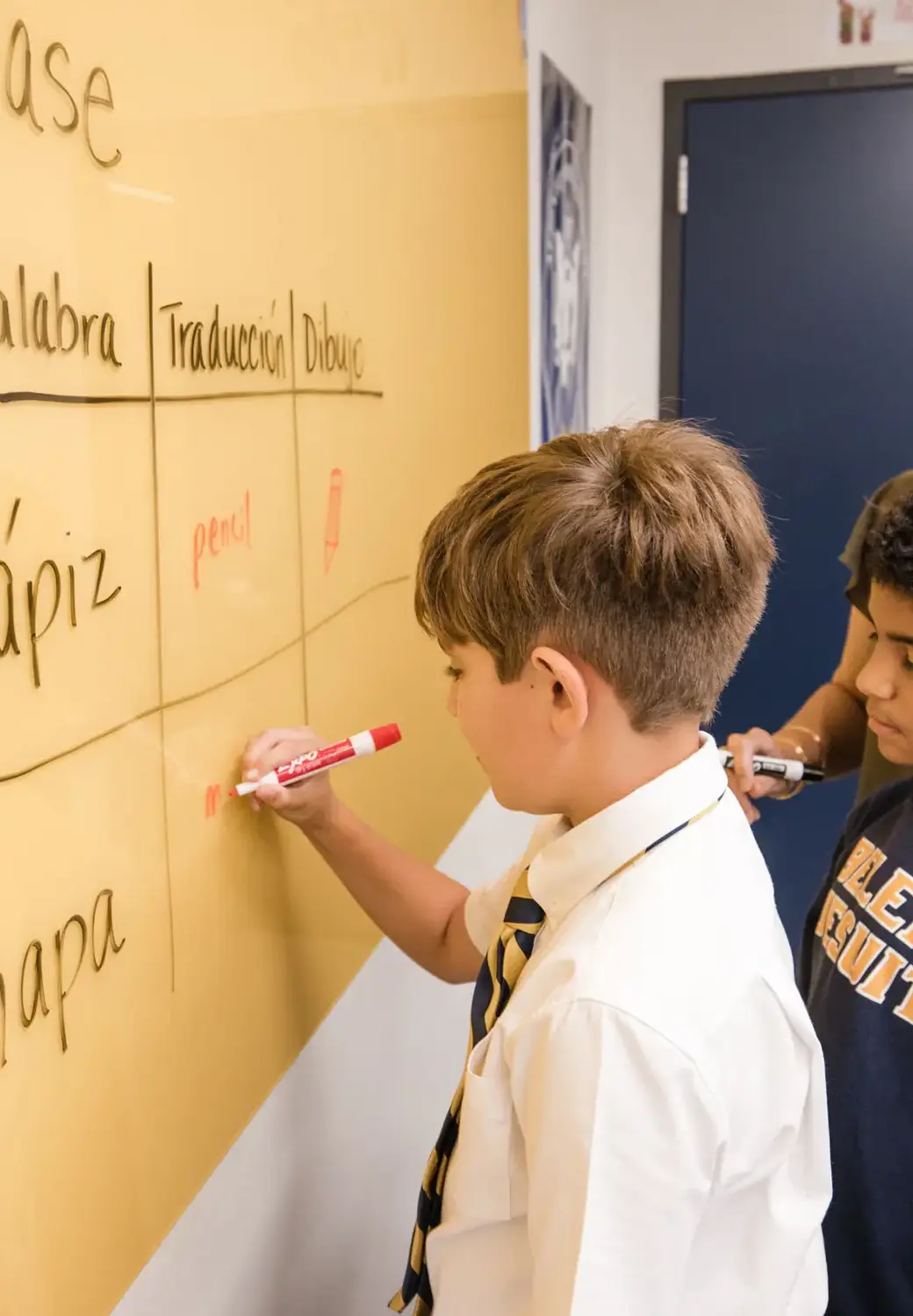 Belen Jesuit student writing on the board in class.