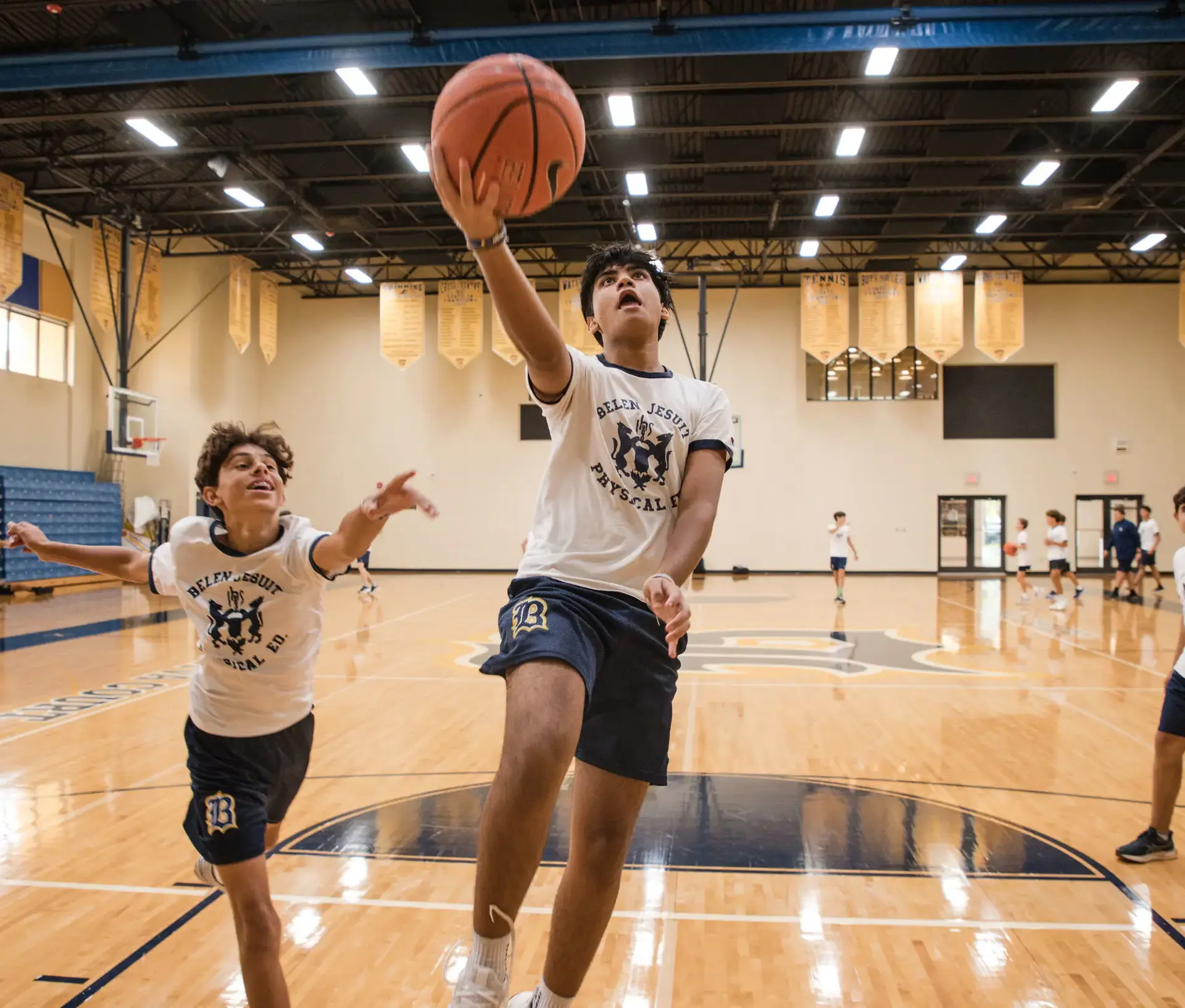 Students playing basketball in the Roberto C. Goizueta Innovation Center gym