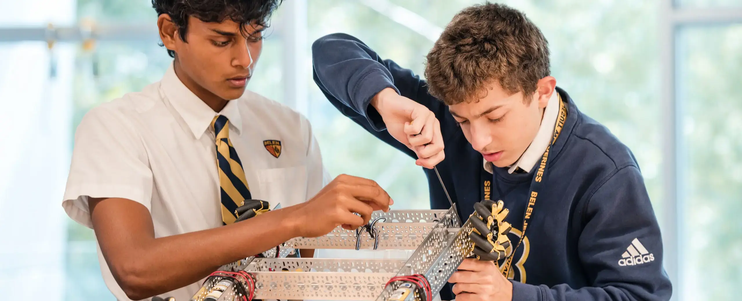 Belen Jesuit students building a robot as part of the STEAM program.