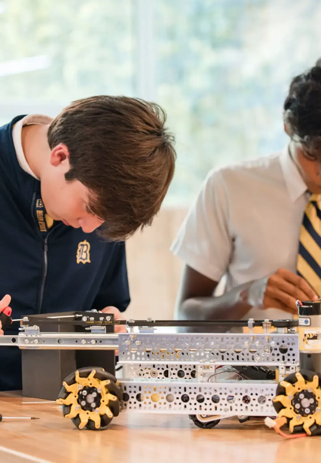 Belen Jesuit students building a robot in a STEAM class.
