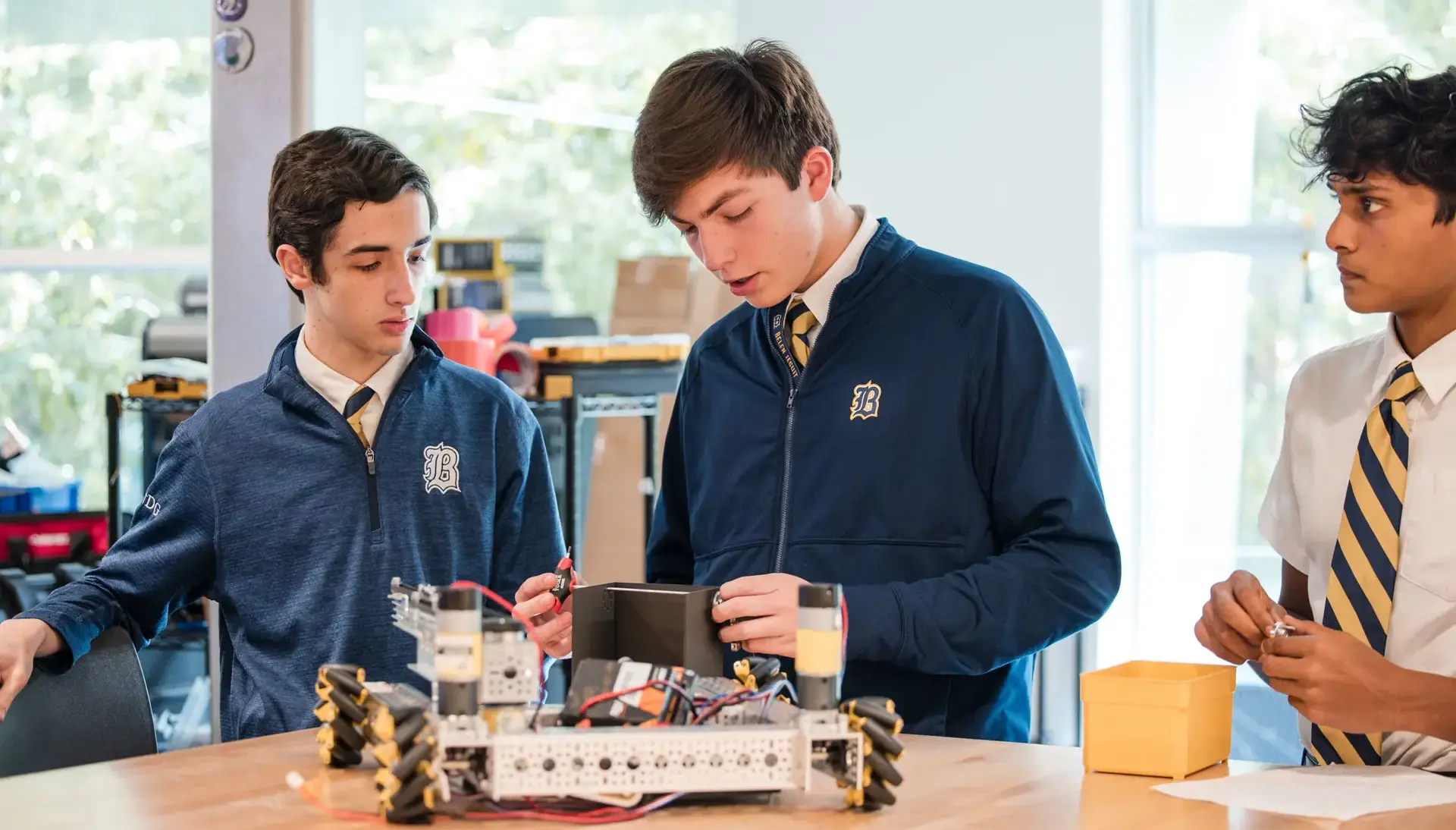 Belen Jesuit students building a robot in a STEAM class.