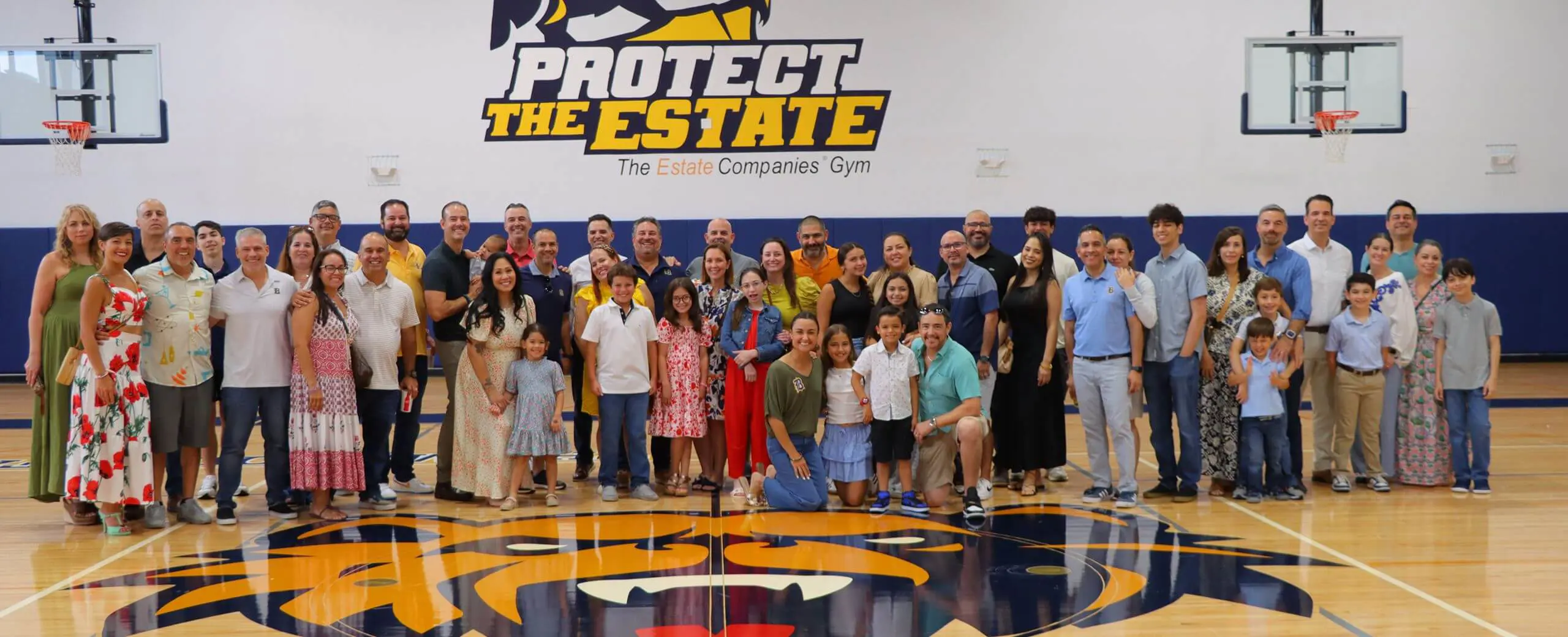 Belen Jesuit alumni group photograph in sports hall.