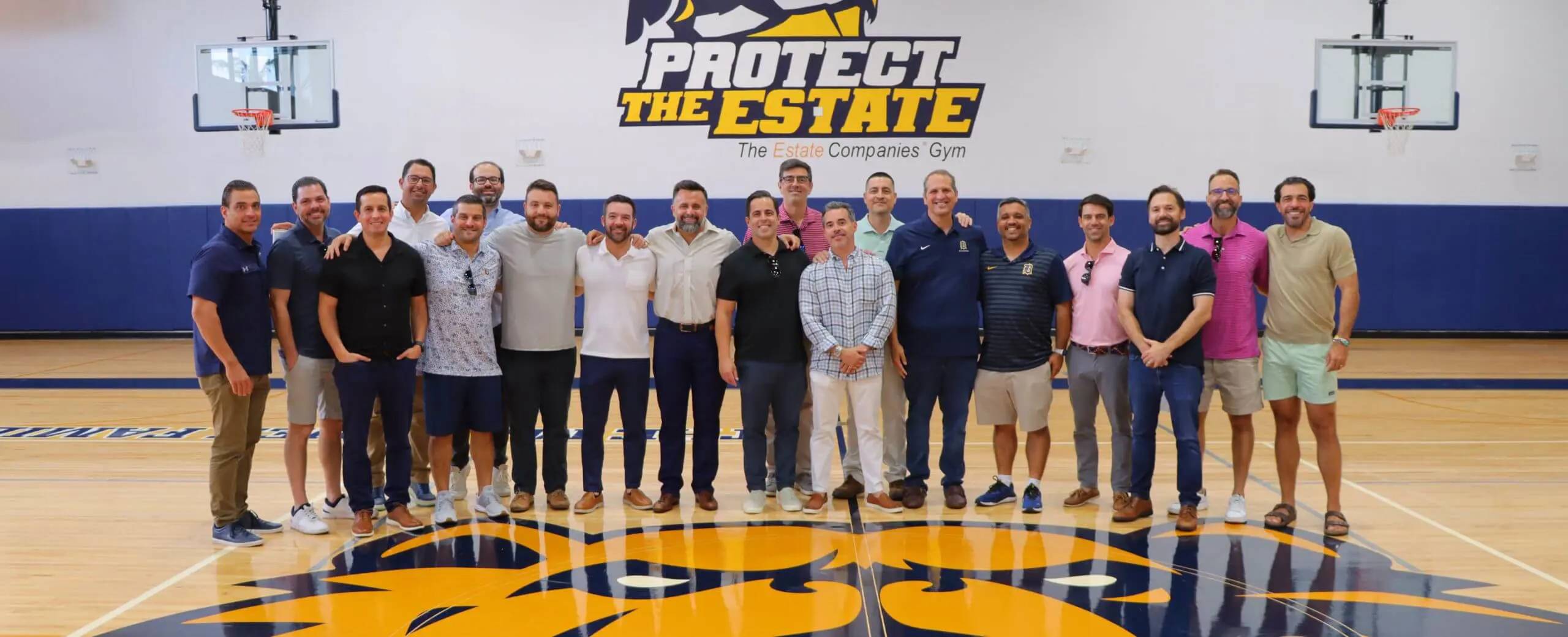 Belen Jesuit alumni group photograph in gymnasium at Grand Reunion event.