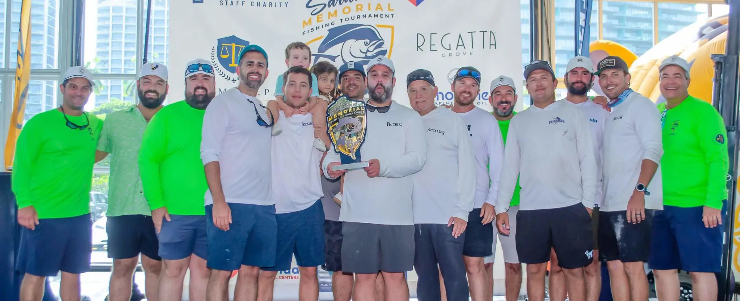 Participants in the Father Sardiña, S.J. Memorial Fishing Tournament and Dock Party holding a trophy.