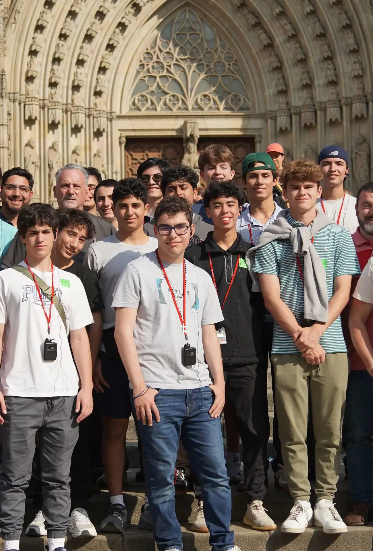Belen Jesuit students on the 2025 Pilgrimage to Spain posing for a group picture on the steps outside the famous Basílica de la Sagrada Família in Barcelona.
