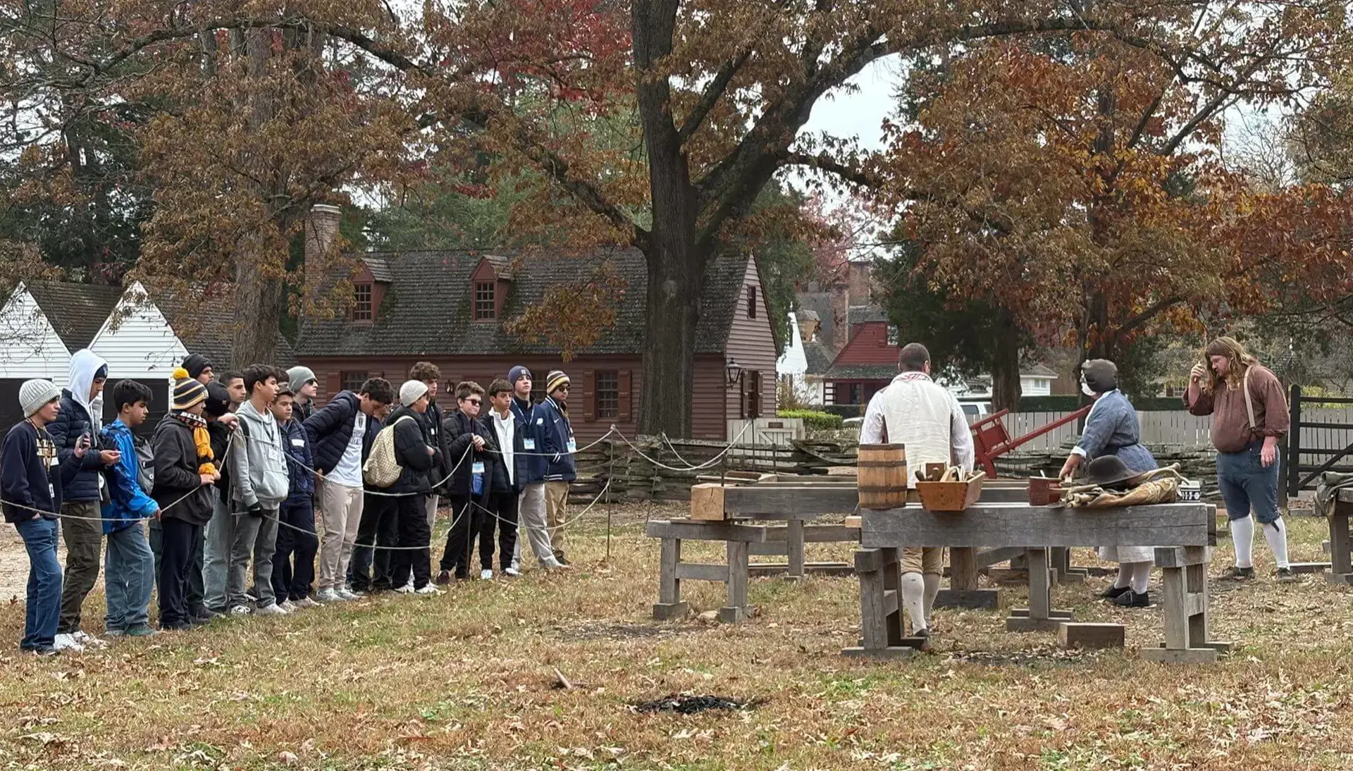 Belen Jesuit students watching an outdoor demonstration at the Founding of a Nation experience field trip.