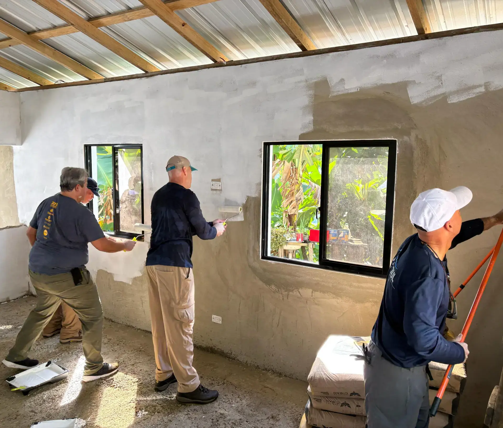 Belen Alumni on the annual mission trip to the Dominican Republic painting a house.