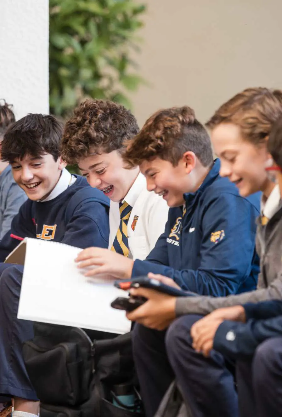 Belen Jesuit students laughing together.