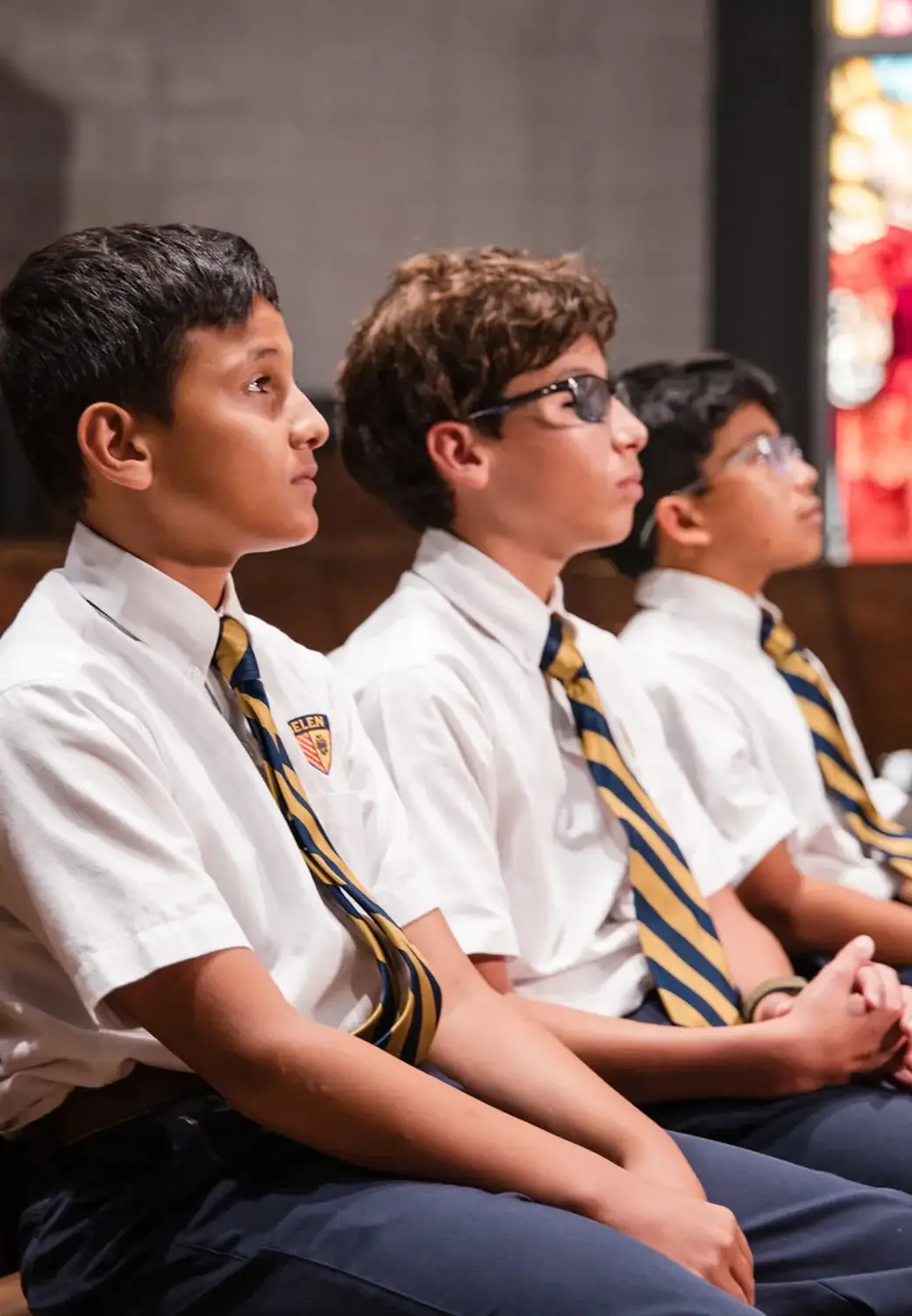 Belen Jesuit students sitting in the Our Lady of Belen Chapel.