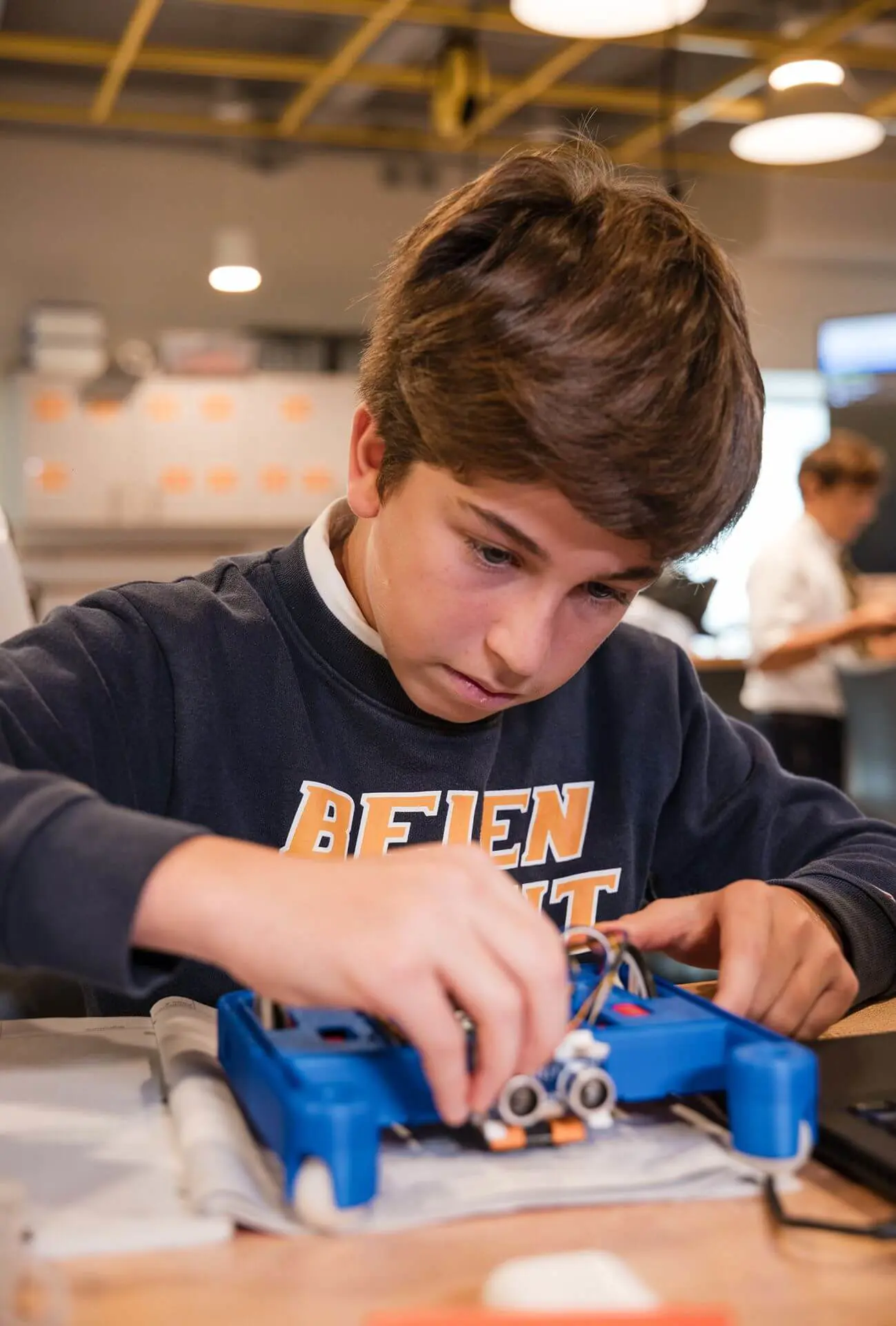 A Belen Jesuit middle school student is assembling a robot during class.