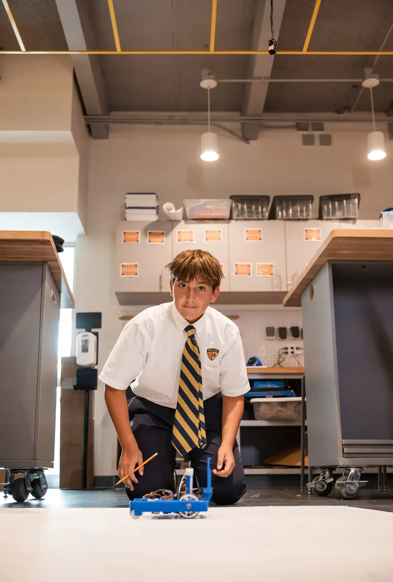 Belen Jesuit student with their robot in a STEAM class.