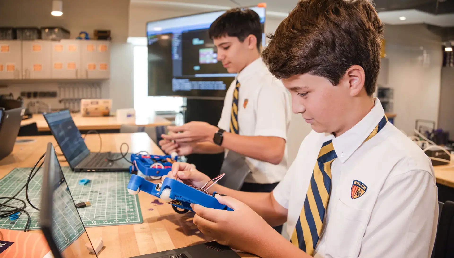 Belen Jesuit students building robots in a STEAM classroom.