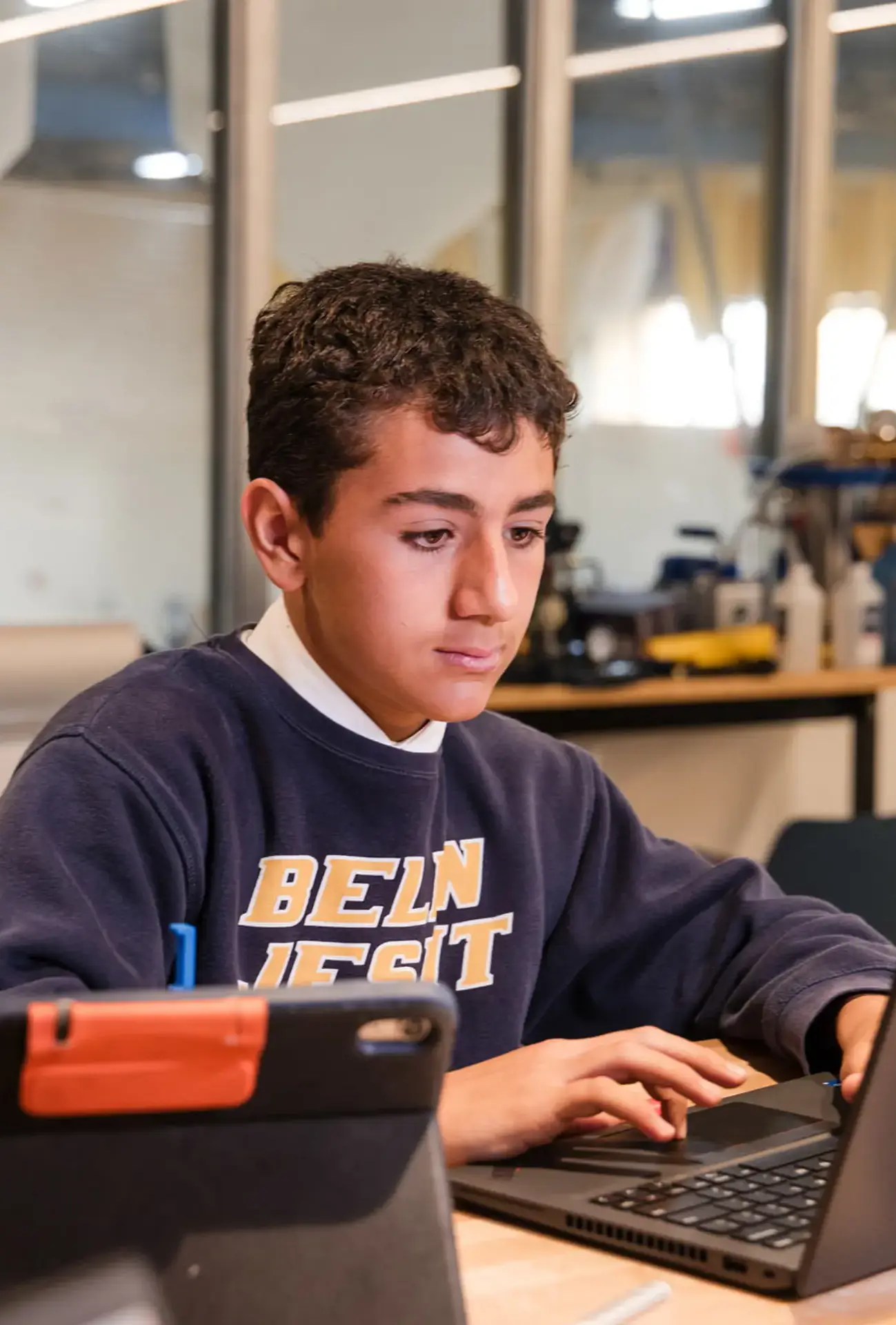 Belen Jesuit student working on laptop in a STEAM class.