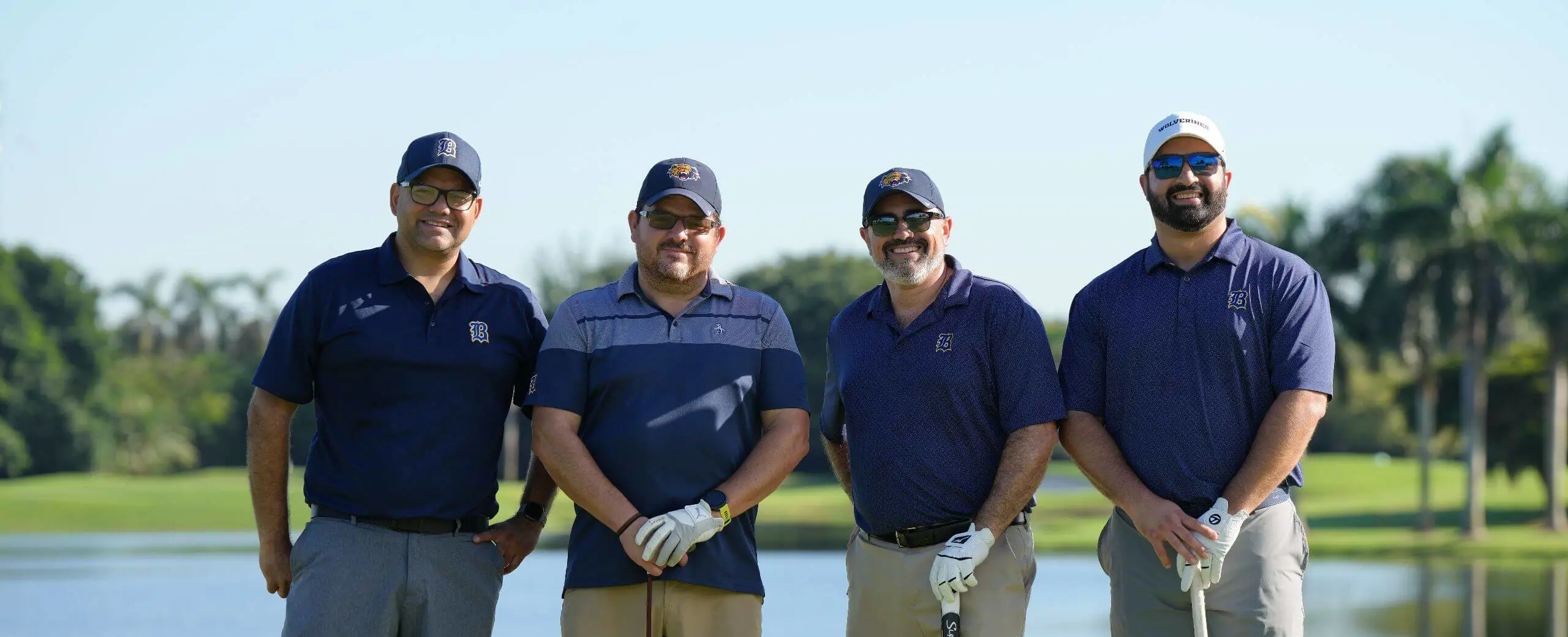 Participants in the Fr. Izquierdo Memorial Golf Tournament posing for a photograph on the golf course.