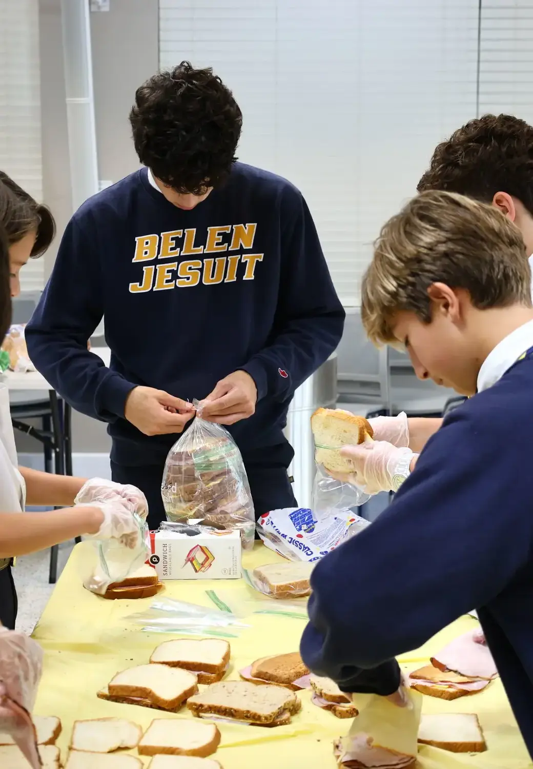Students wrapping food for charity