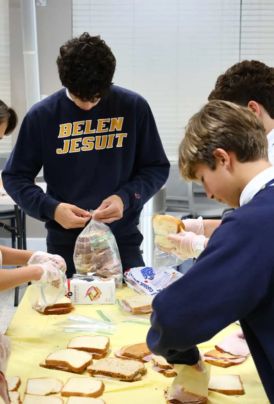 Belen Jesuit students making sandwiches as part of the Christian Service Program.
