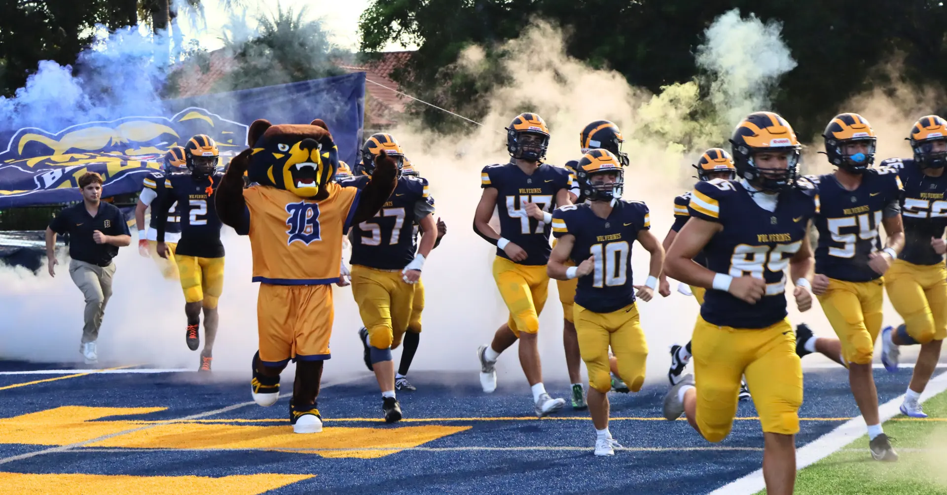 Waldo the Wolverine running out of the tunnel with the football team in 2025.