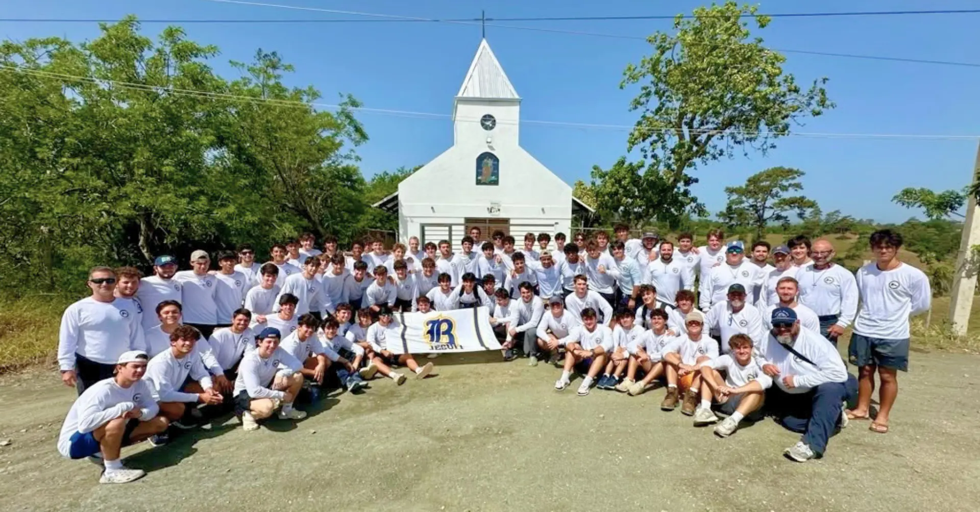 Students participating in the 2026 Belen Youth Mission pose in front the chapel.