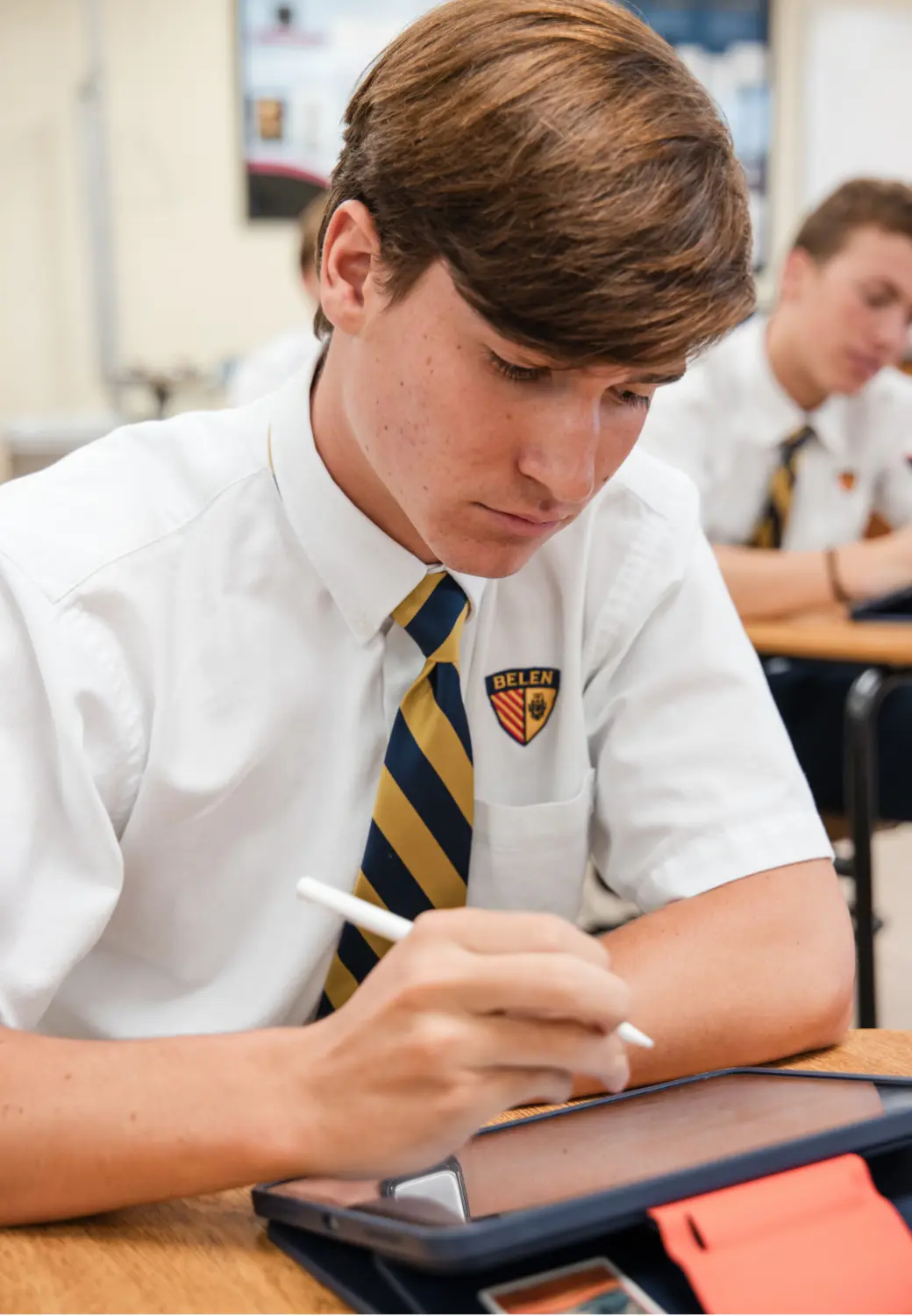 Belen Jesuit high school teacher helping a student in class.