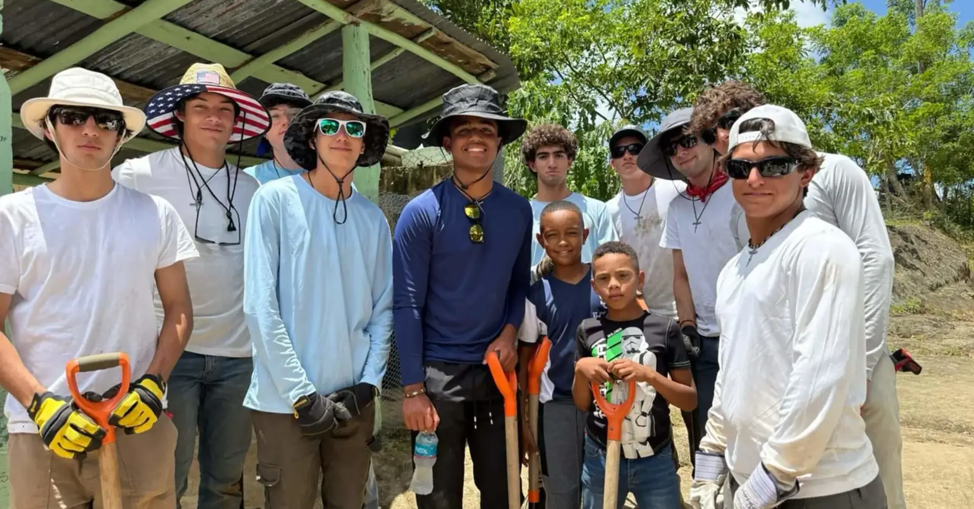 Students participating in the 2025 Belen Youth Mission holding tools and shovels.