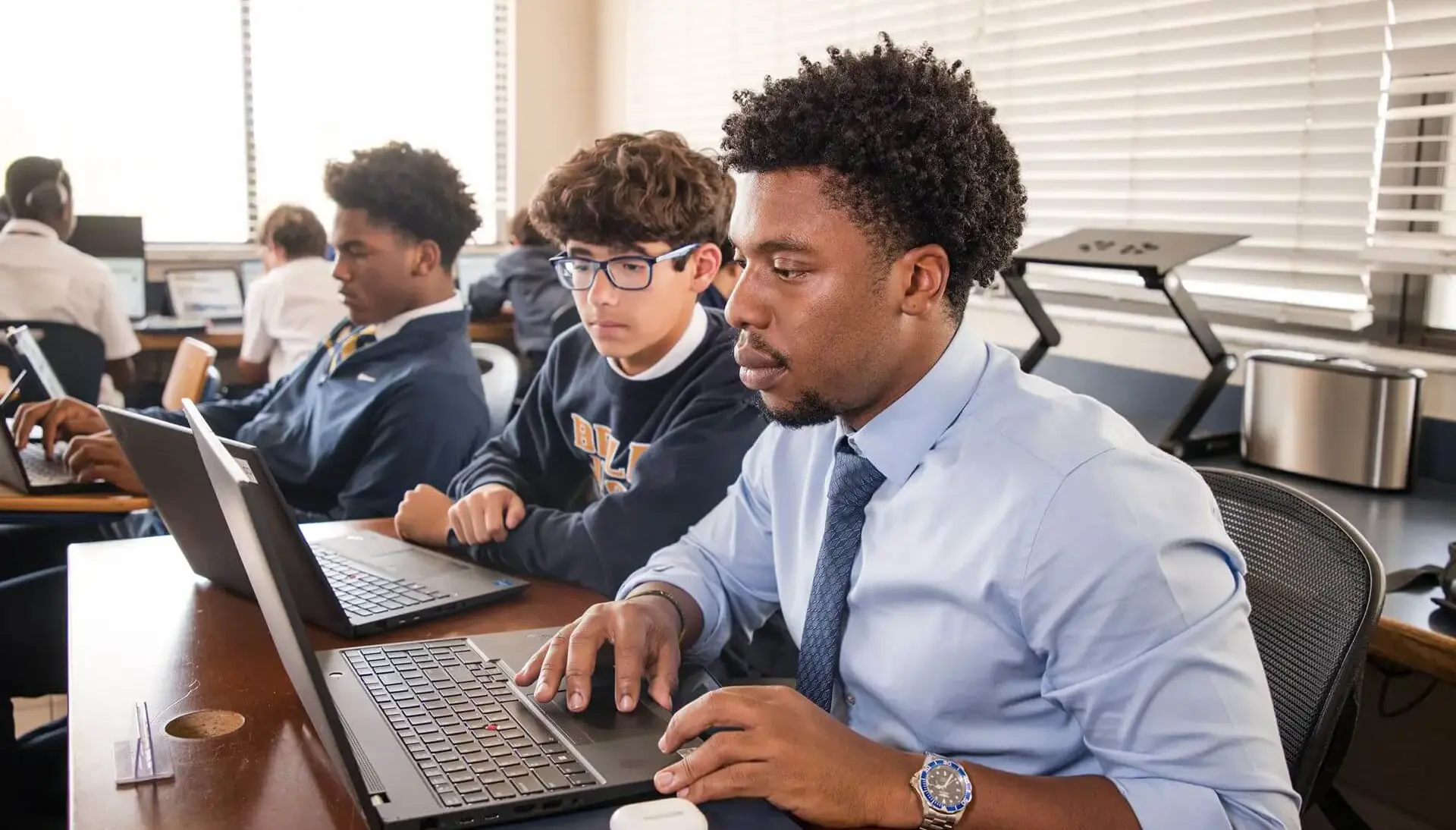Students at Belen Jesuit receive one-on-one instruction from their Computer Science teacher.