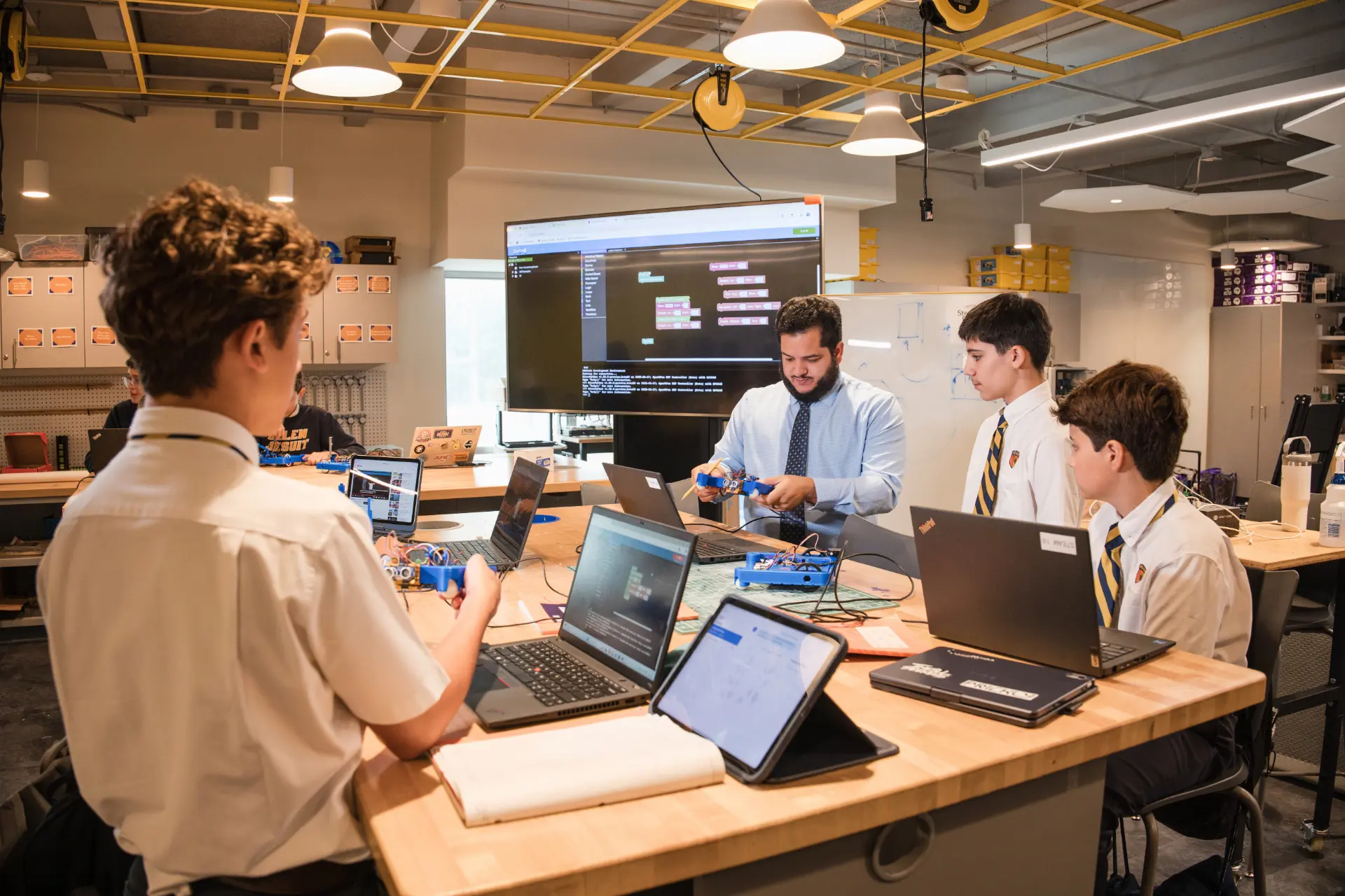 Belen Jesuit students learning how to code during a robotics class. 