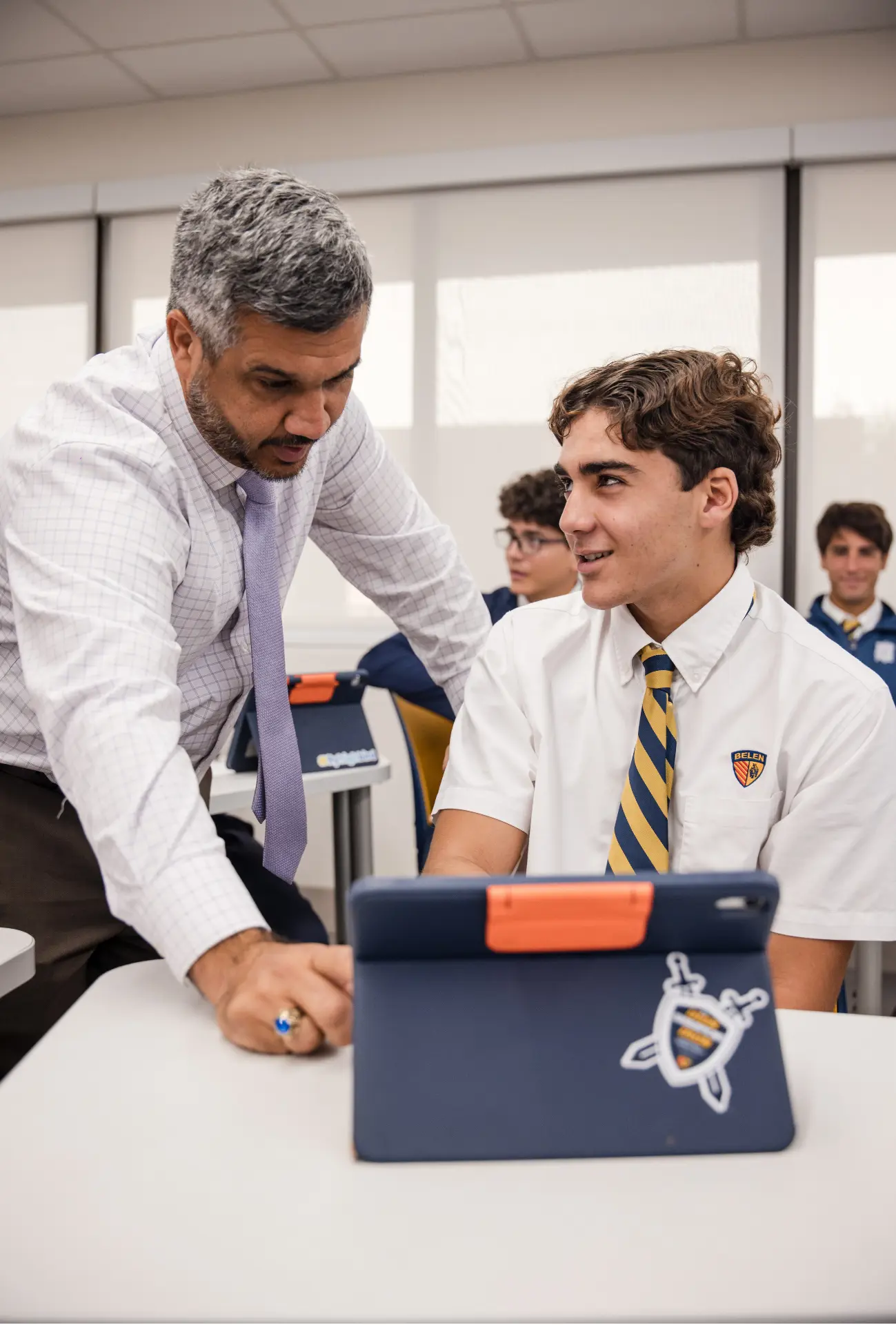 M. Jose Andion helps one of his history students with a lesson.