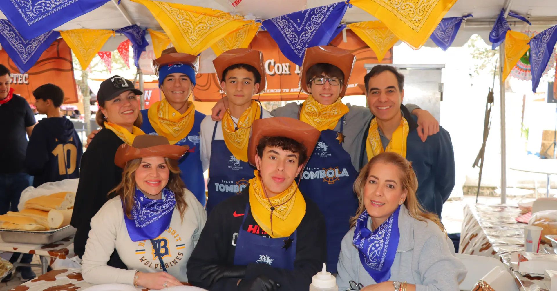 Belen Jesuit parents and sons working together at a class booth during Tombola.