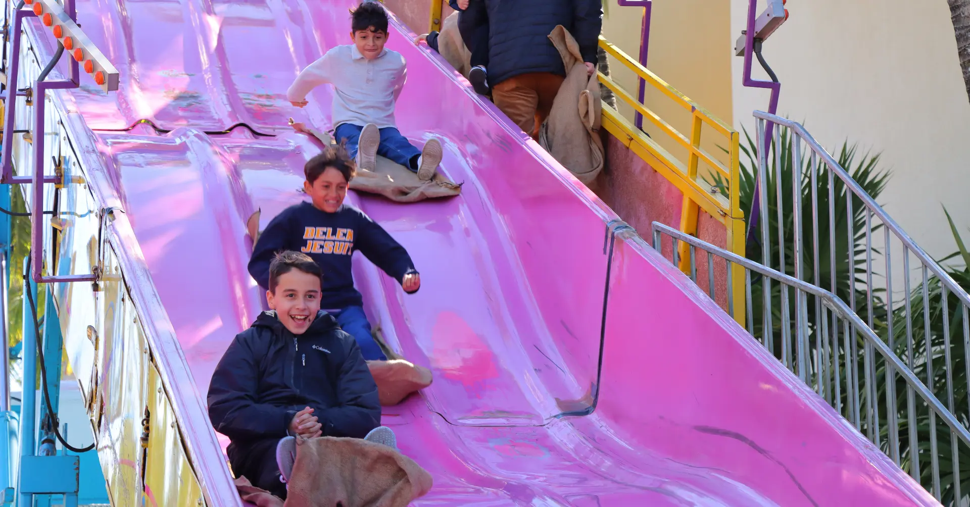 Belen students ride the giant slide at Tombola.