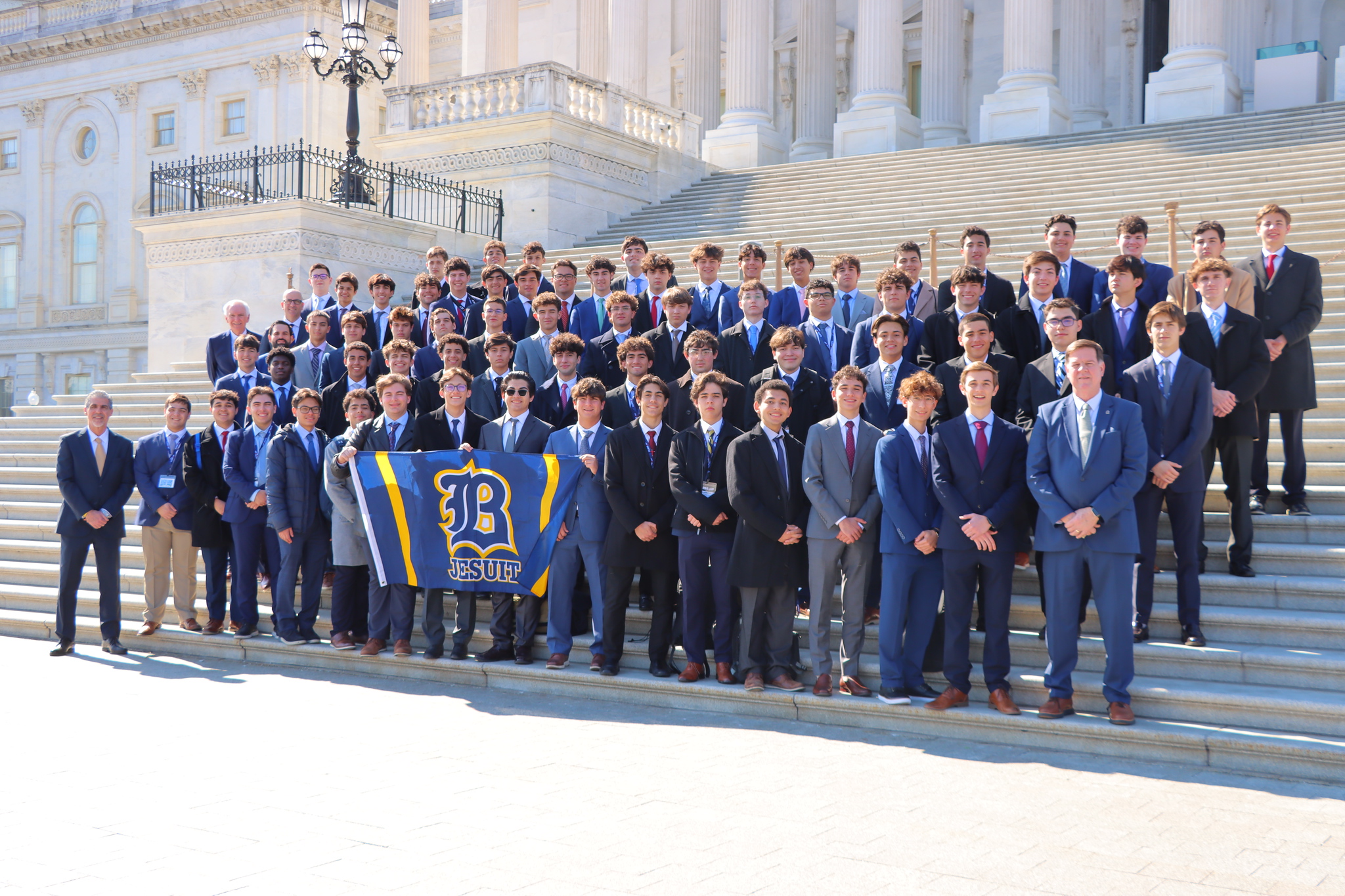 Belen Jesuit students holding a Belen flag in D.C.